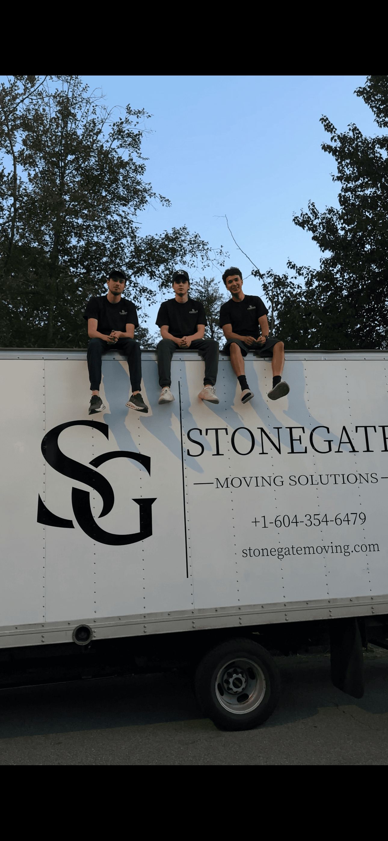 Stonegate team sitting on top of the truck