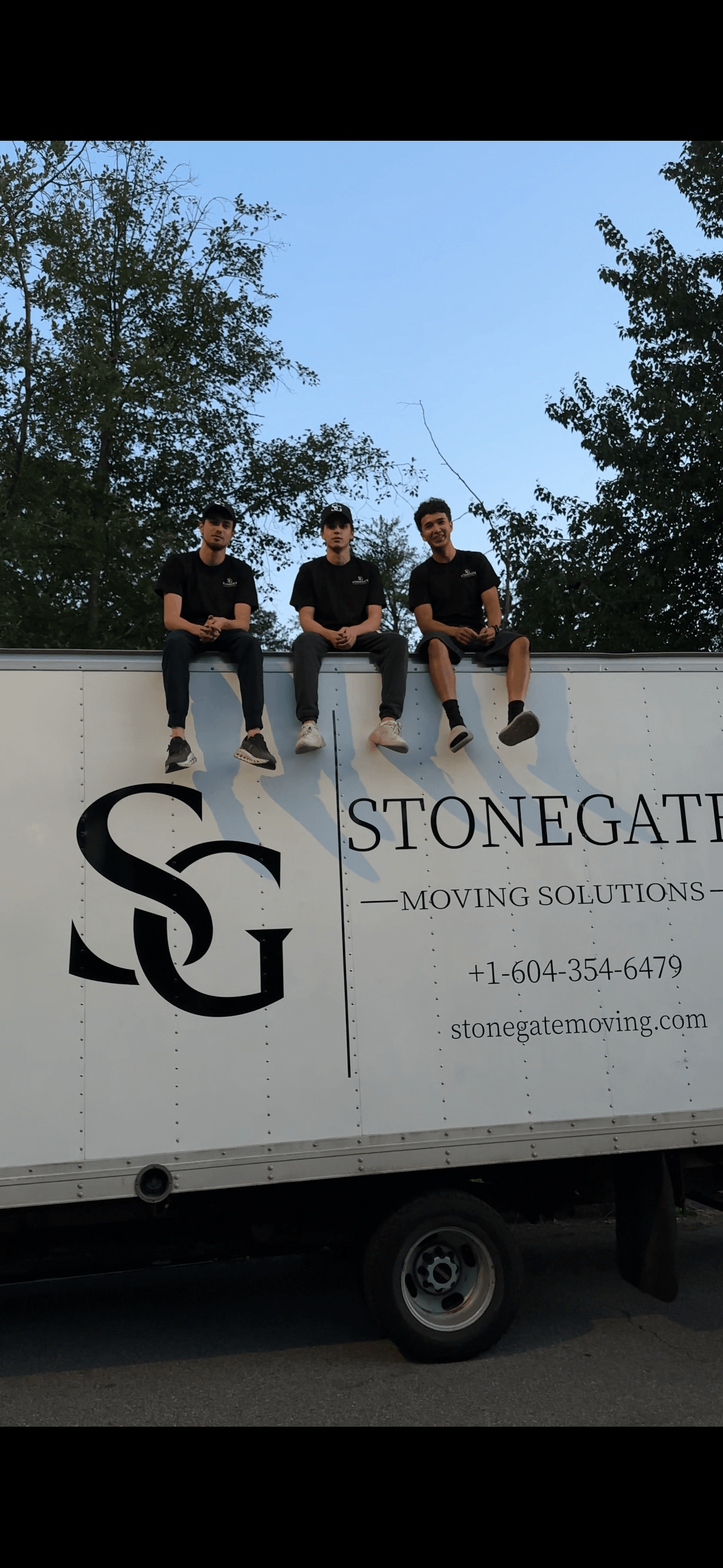 The Stonegate crew sitting on top of the branded Stonegate truck