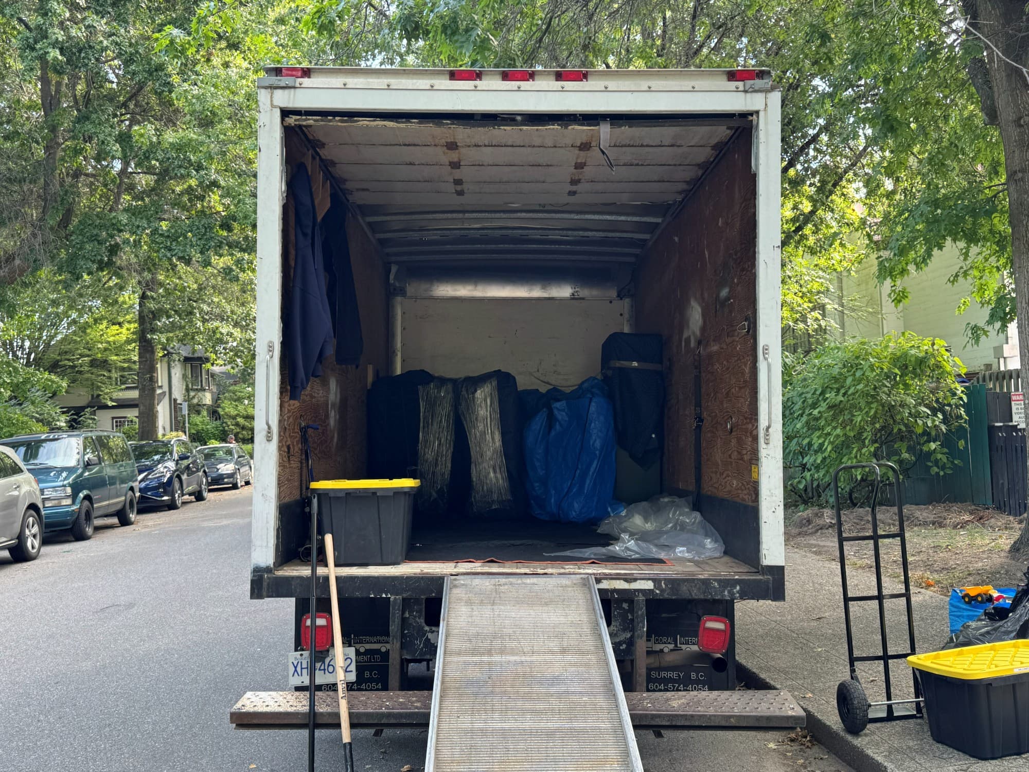 Stonegate moving truck loaded with wrapped furniture on a Burnaby street
