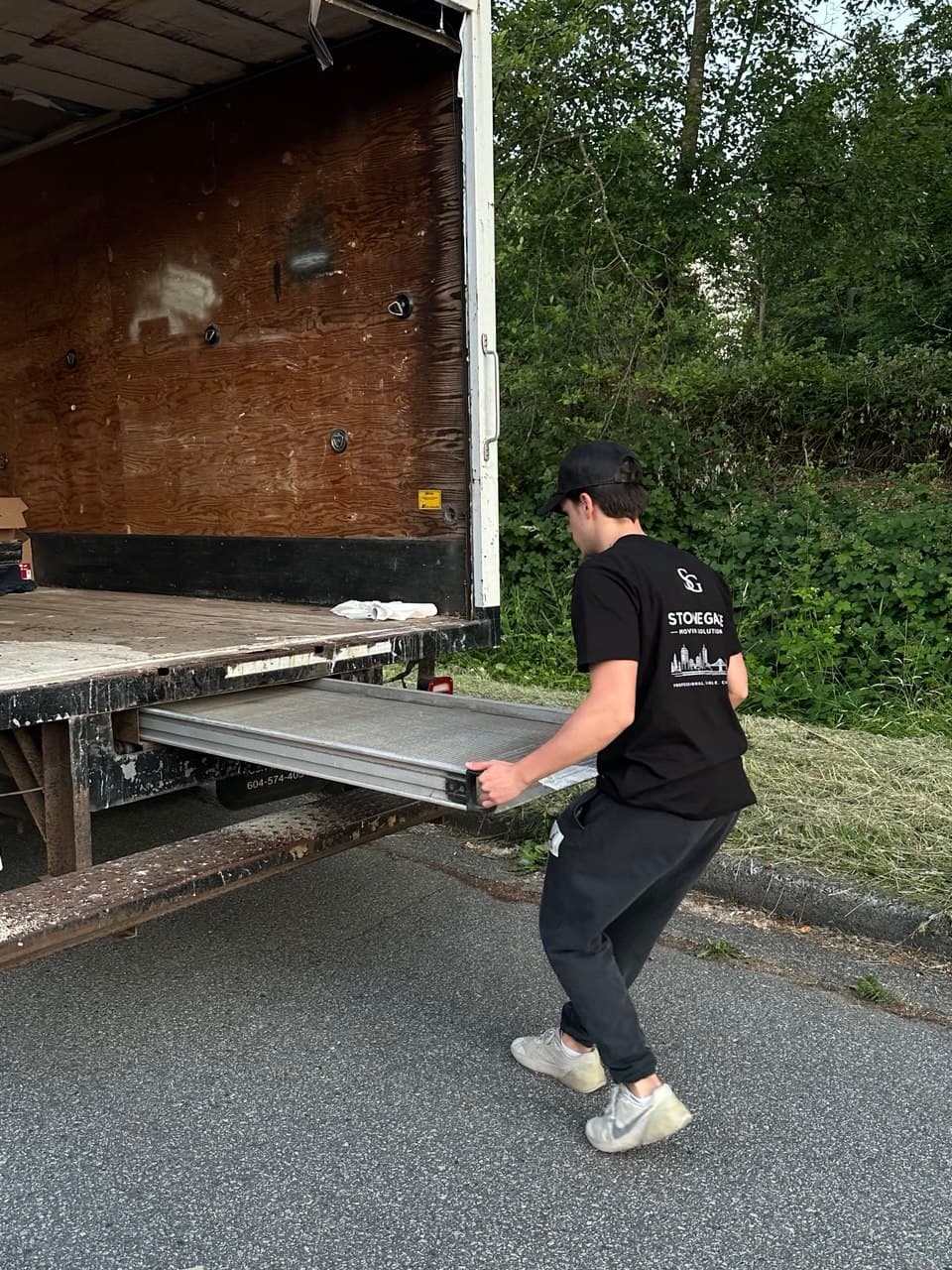 Stonegate crew loading a moving truck outside an apartment building