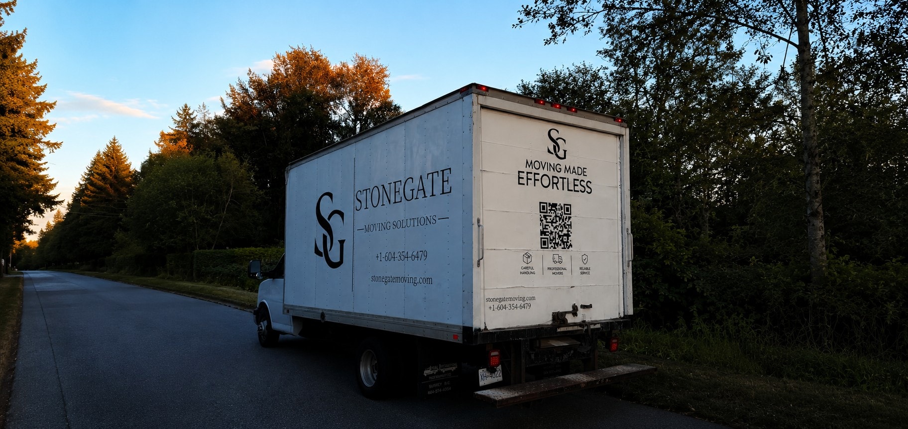 Stonegate moving truck on a Port Coquitlam street at dusk
