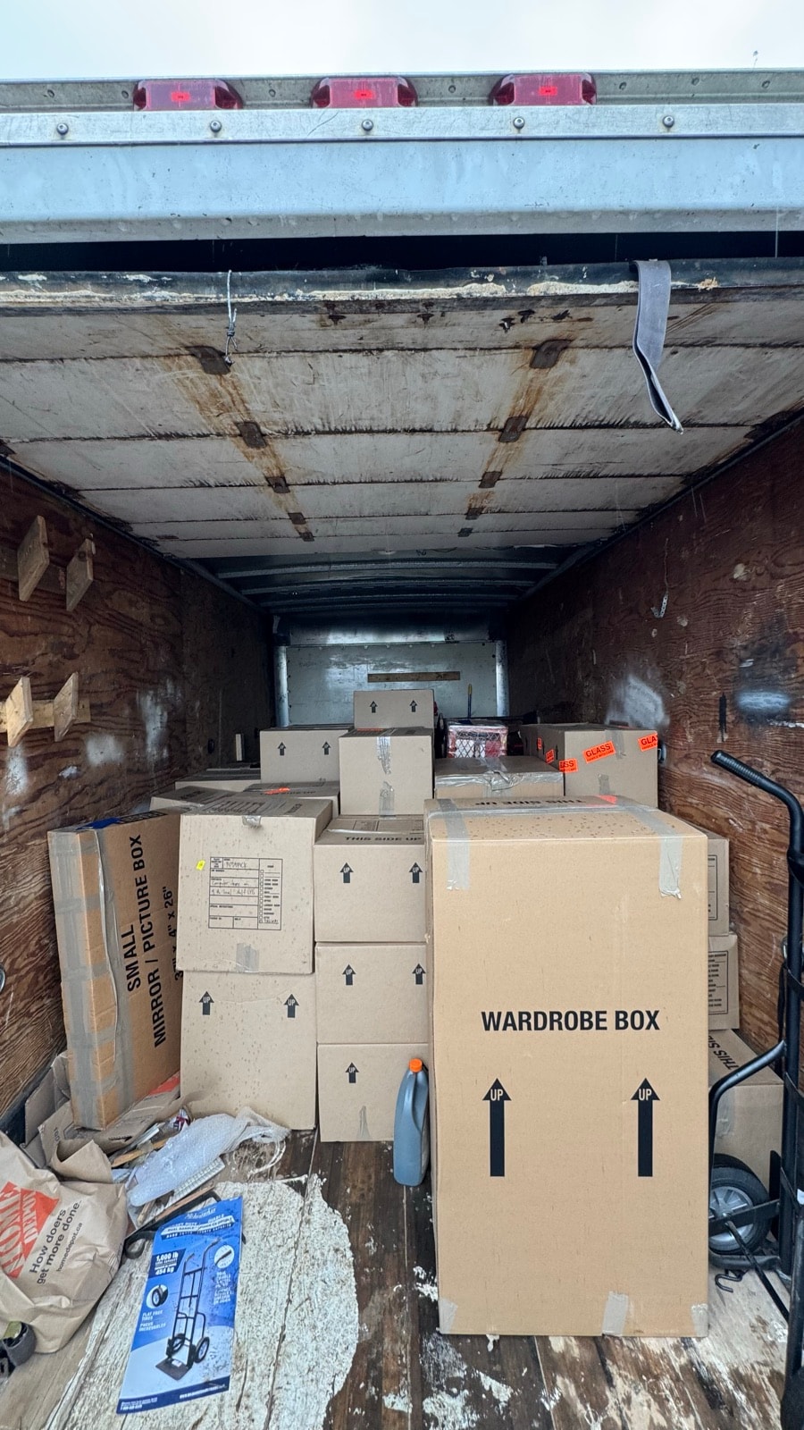 Stonegate truck loaded with moving boxes and wardrobe boxes for cardboard removal
