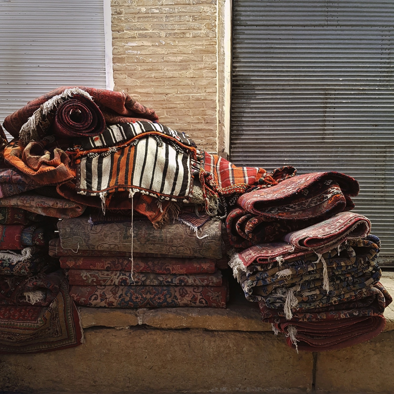 Stacks of old rugs and rolled carpets piled up for carpet and rug removal