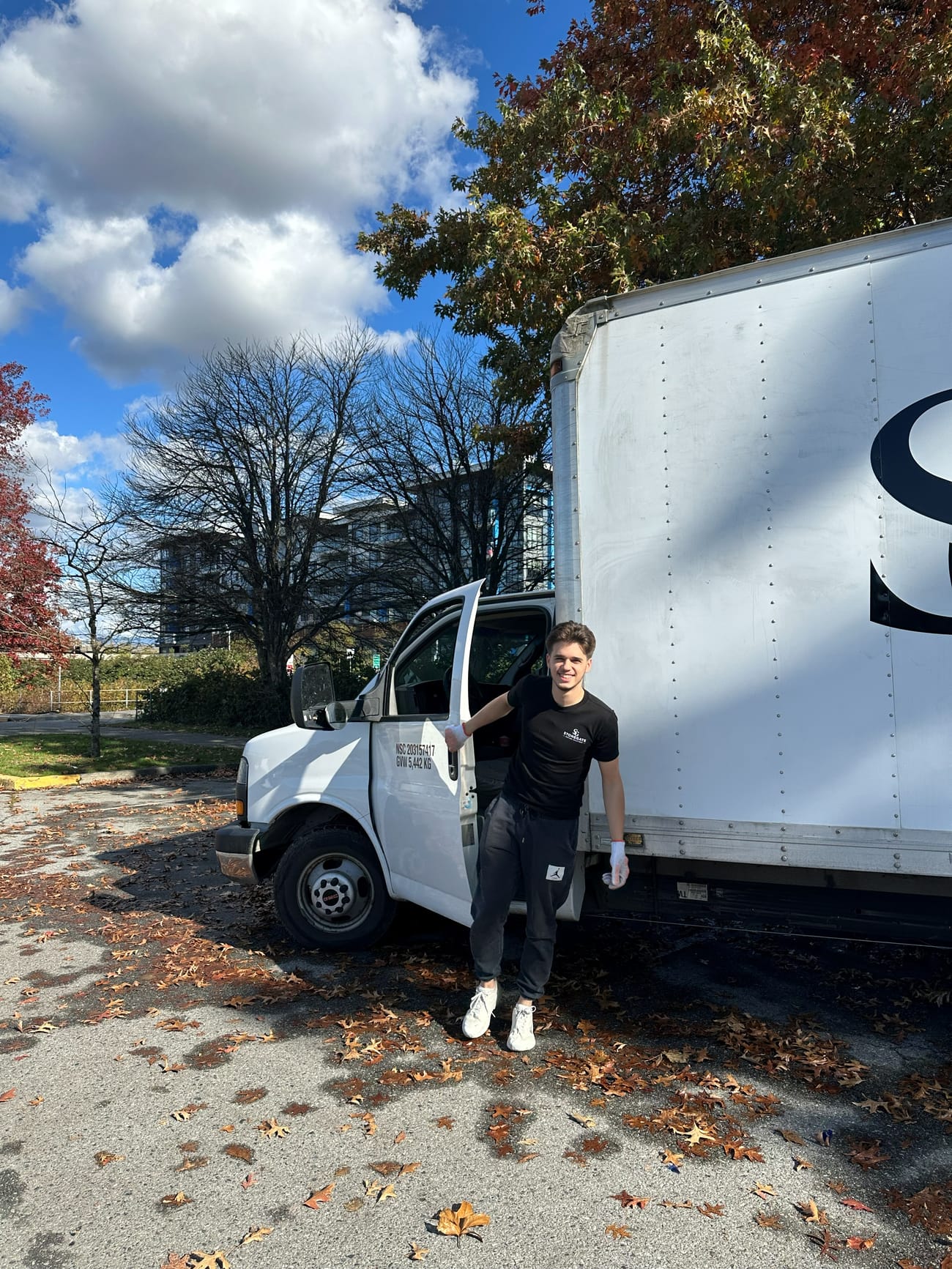 Stonegate crew member standing beside the cab of the Stonegate truck