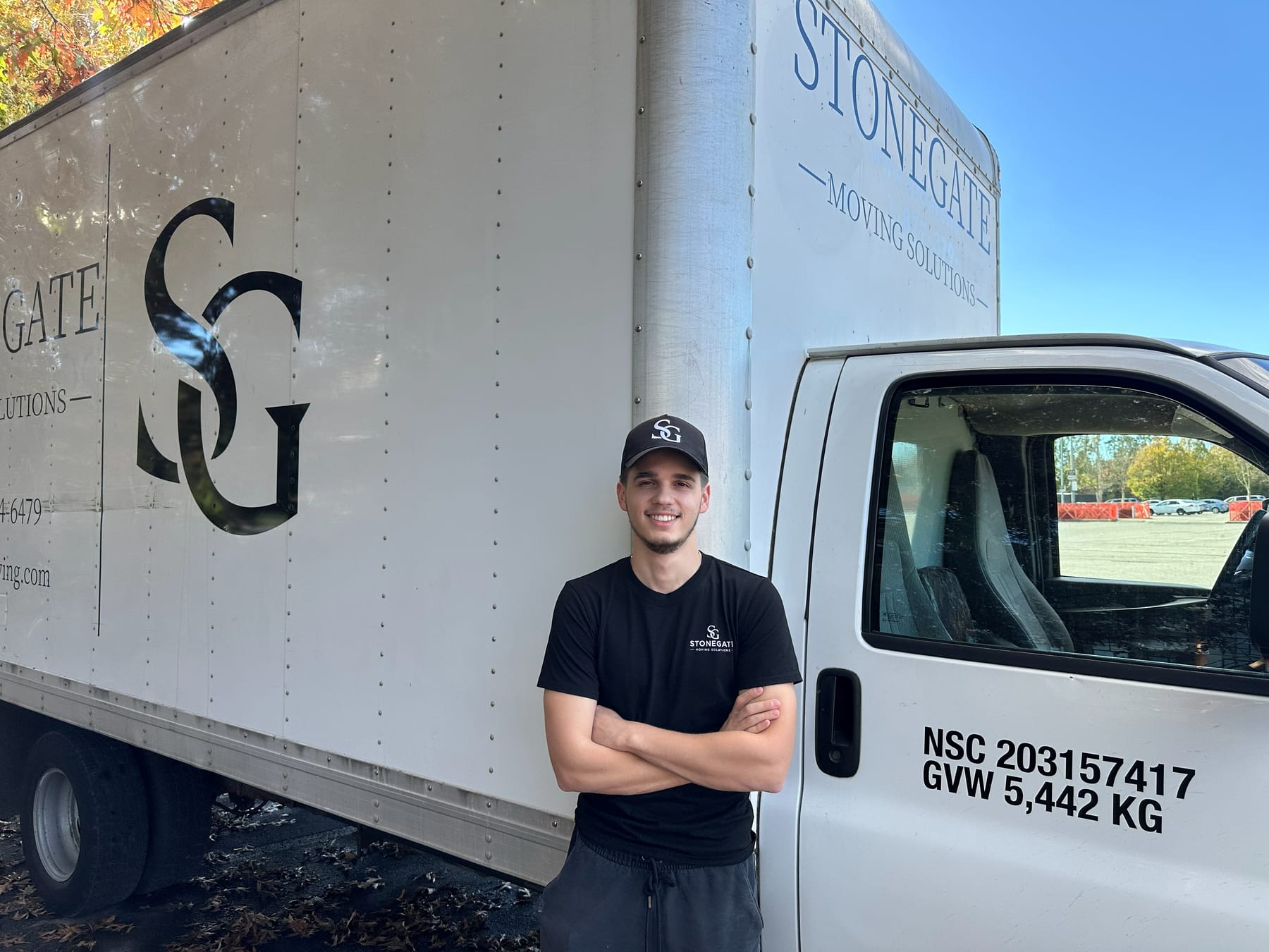 Stonegate crew member standing beside the branded Stonegate truck