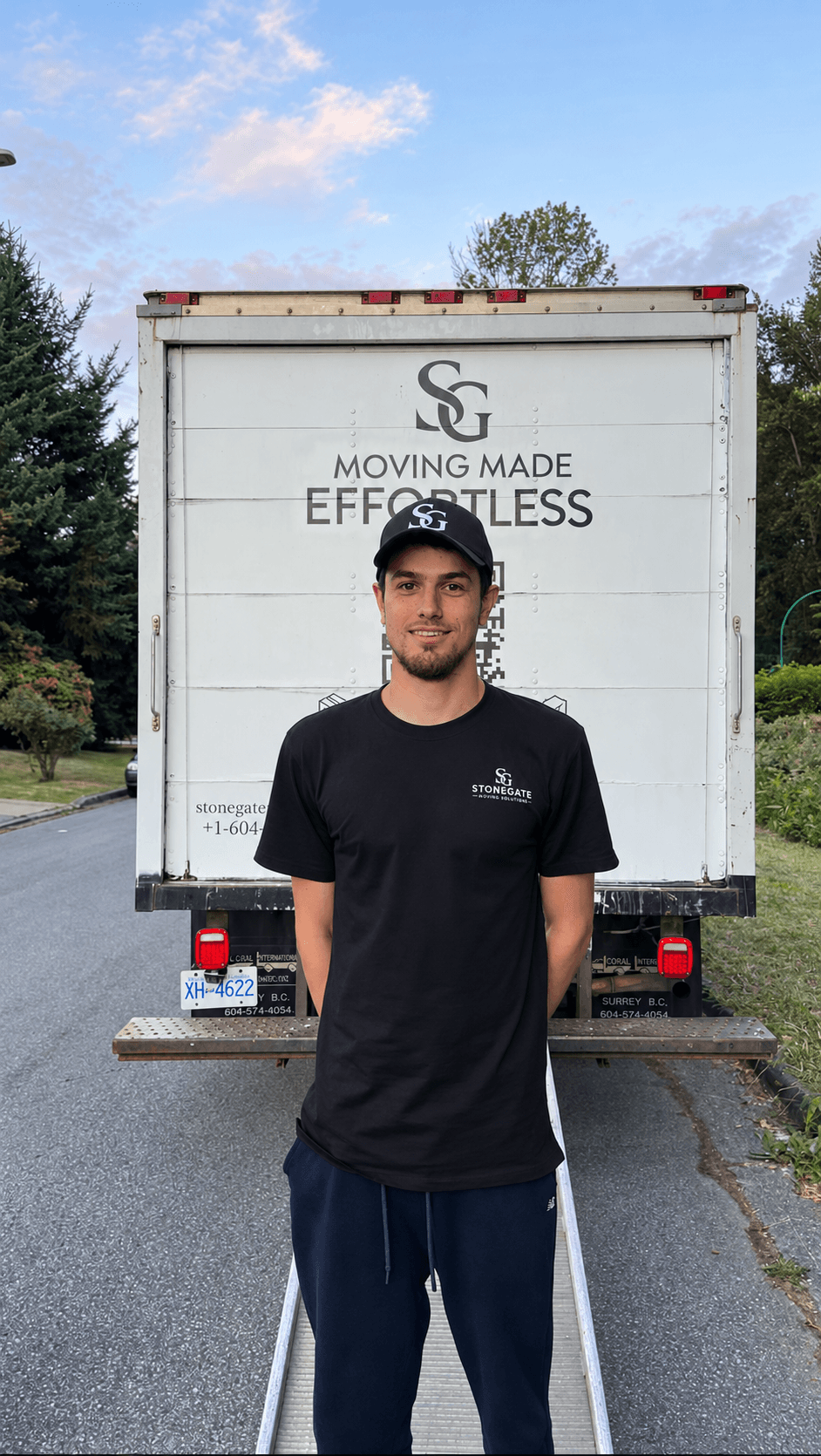Stonegate crew member standing at the back of the Stonegate truck