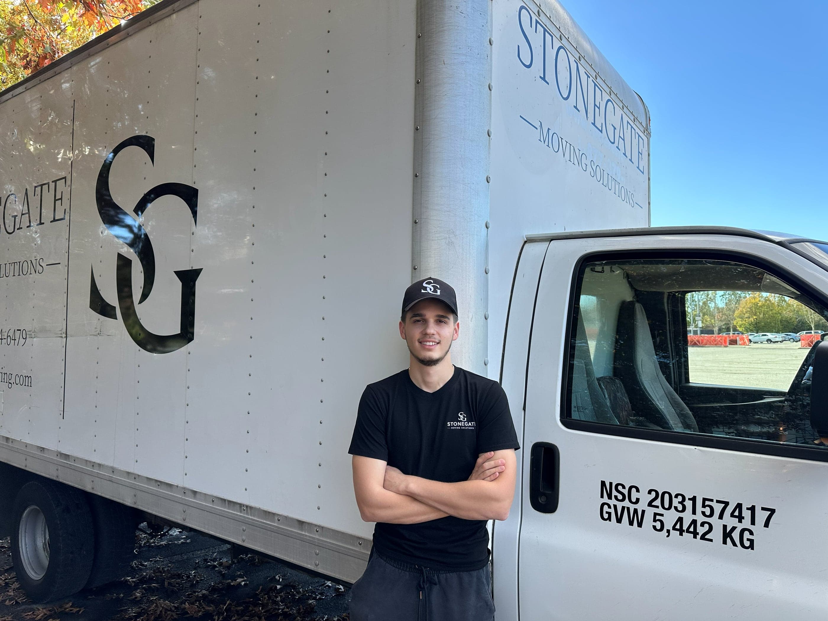 A Stonegate mover standing in front of the branded truck