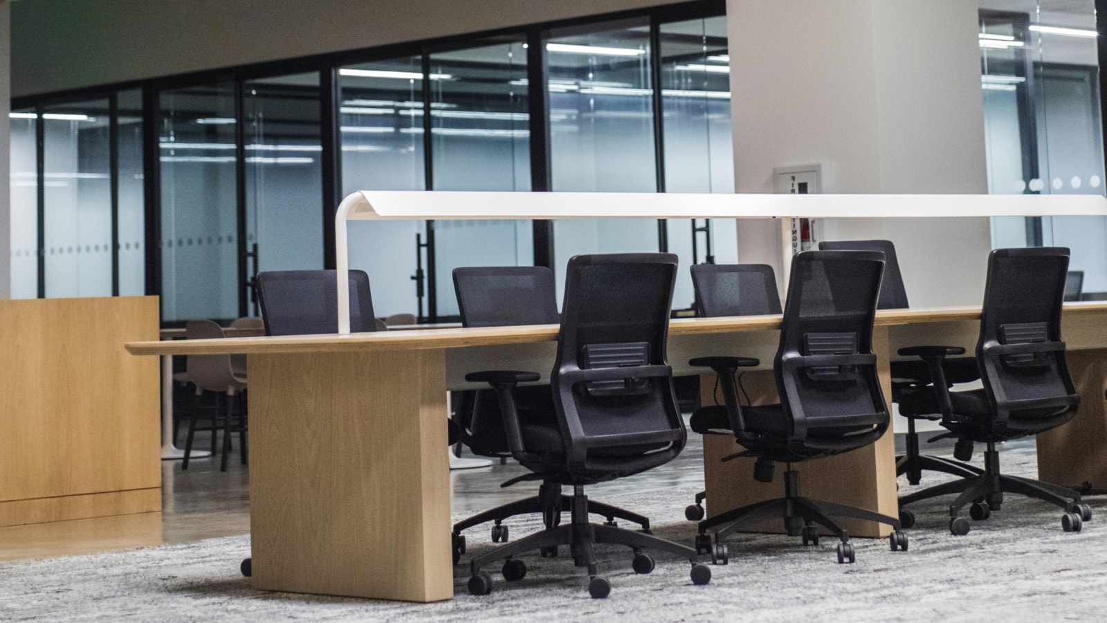 Row of office chairs and a long desk ready for office furniture removal