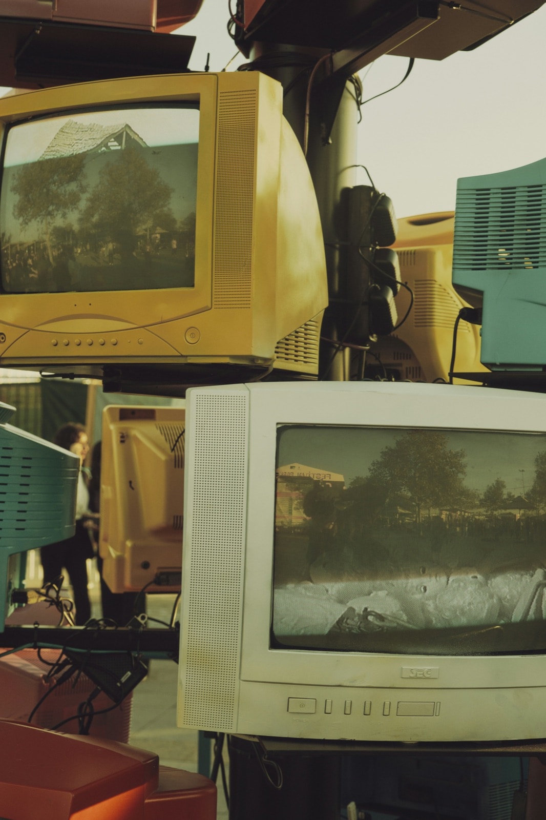 Stack of old CRT tube televisions waiting for TV removal and disposal
