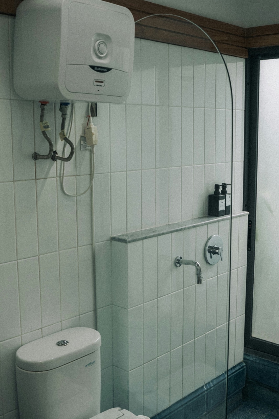 Wall-mounted electric water heater ready to be disconnected and removed