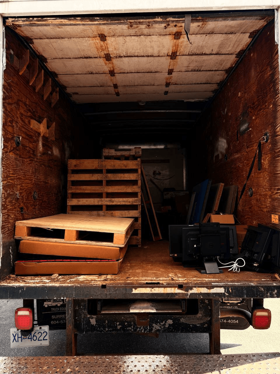 Stonegate truck bed loaded with junk removal items